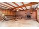 Living room with brick fireplace, exposed beamed ceiling, and sliding glass doors at 123 Se 1St Ave, Webster, FL 33597
