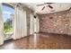 Room features brick and stone wall, tile floor and windows with curtains at 123 Se 1St Ave, Webster, FL 33597