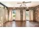 Sunroom with stone walls, brick accent, tile floor, and a ceiling fan at 123 Se 1St Ave, Webster, FL 33597