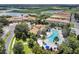 Aerial view showcasing the large community pool and well maintained grounds near a golf course and lake at 1246 Payne Stewart Dr, Davenport, FL 33896