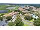 Aerial view of the community clubhouse and surrounding grounds with a golf course, lake, and neighborhood at 1246 Payne Stewart Dr, Davenport, FL 33896