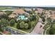 Aerial view of the gated community entrance, pool and clubhouse with well-maintained landscaping at 1246 Payne Stewart Dr, Davenport, FL 33896