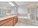 Bathroom featuring double sinks, soaking tub, and glass-enclosed shower at 1246 Payne Stewart Dr, Davenport, FL 33896