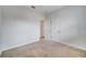This bedroom features neutral carpet and trim and access to an additional room through a double-door entrance at 1246 Payne Stewart Dr, Davenport, FL 33896