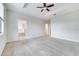 Large carpeted bedroom with ceiling fan and en-suite bathroom at 1246 Payne Stewart Dr, Davenport, FL 33896