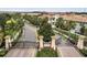 View of a gated community entrance with lush landscaping and palm tree-lined streets at 1246 Payne Stewart Dr, Davenport, FL 33896