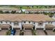 Exterior elevation of well-maintained townhomes with attached garages, brick-paved driveways, and landscaping at 1246 Payne Stewart Dr, Davenport, FL 33896