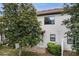 Exterior view of home with small patio, lush landscaping, and view of windows at 1246 Payne Stewart Dr, Davenport, FL 33896