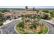 Exterior view of the community clubhouse featuring lush landscaping, a water feature, and ample parking at 1246 Payne Stewart Dr, Davenport, FL 33896