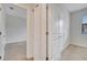 This hallway features neutral carpet and trim, access to other rooms, and a linen closet at 1246 Payne Stewart Dr, Davenport, FL 33896