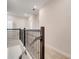 Upstairs hallway featuring carpeted floors, a staircase with metal railings, and white walls at 1246 Payne Stewart Dr, Davenport, FL 33896
