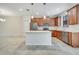 Bright kitchen featuring stainless steel appliances, wooden cabinets, and a white island at 1246 Payne Stewart Dr, Davenport, FL 33896
