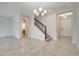 Cozy living room with tile flooring, staircase access, and a door to the outside at 1246 Payne Stewart Dr, Davenport, FL 33896