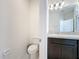 Half bathroom featuring a vanity with dark cabinets and a toilet at 129 Boydfield Ln, Davenport, FL 33837