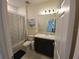 Clean and bright bathroom with a shower and vanity, complemented by tile flooring and soft lighting at 129 Boydfield Ln, Davenport, FL 33837