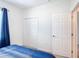 Bright bedroom featuring a double door closet and neutral color scheme at 129 Boydfield Ln, Davenport, FL 33837