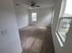 Bright, airy bedroom with carpet, large windows, neutral walls and a ceiling fan at 129 Boydfield Ln, Davenport, FL 33837