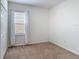 Cozy bedroom featuring plush carpeting, a bright window, and a closet for ample storage at 129 Boydfield Ln, Davenport, FL 33837