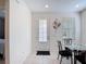 Bright dining area featuring tile flooring, a glass table set, and natural light from a window at 129 Boydfield Ln, Davenport, FL 33837