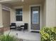 Inviting front porch with cozy seating, creating a welcoming entrance at 129 Boydfield Ln, Davenport, FL 33837