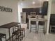 Modern kitchen area with stainless steel appliances and breakfast bar at 129 Boydfield Ln, Davenport, FL 33837