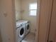 A convenient laundry room featuring a washer and dryer with a window that provides natural light at 129 Boydfield Ln, Davenport, FL 33837