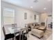 Inviting living room area with comfortable seating, neutral decor, and a dining area, perfect for relaxation at 129 Boydfield Ln, Davenport, FL 33837