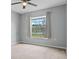 Cozy bedroom with a large window offering plenty of natural light and backyard views at 135 Inconnu Ct, Kissimmee, FL 34759