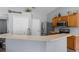 Kitchen with wooden cabinets, stainless appliances, breakfast bar, and modern countertops at 135 Inconnu Ct, Kissimmee, FL 34759