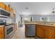Modern kitchen features stainless steel appliances and wood cabinets at 135 Inconnu Ct, Kissimmee, FL 34759
