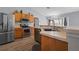 Bright kitchen featuring stainless steel appliances, wood cabinets, and hardwood floors at 135 Inconnu Ct, Kissimmee, FL 34759