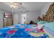 Main bedroom with a ceiling fan, a door to the bathroom, and a wooden dresser at 135 Inconnu Ct, Kissimmee, FL 34759