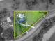 An aerial view of a property highlighting its boundary with green lawns, mature trees, and refreshing pool at 1415 Brumley Rd, Chuluota, FL 32766