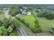 Expansive aerial view of sprawling property with custom home, pool and lush green landscaping at 1415 Brumley Rd, Chuluota, FL 32766
