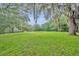 Spacious backyard featuring lush greenery and mature trees, offering tranquility and privacy at 1415 Brumley Rd, Chuluota, FL 32766