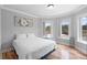 Cozy bedroom with a comfortable bed, hardwood floors, and a bright window for natural light at 1415 Brumley Rd, Chuluota, FL 32766