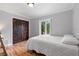 Bedroom with a comfortable bed, hardwood floors, and a bright window for natural light at 1415 Brumley Rd, Chuluota, FL 32766