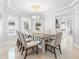 Elegant dining room with neutral colors, chandelier lighting, and windows at 1415 Brumley Rd, Chuluota, FL 32766