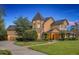 An attractive two-story home showcasing a turret and beautifully manicured front lawn at 1415 Brumley Rd, Chuluota, FL 32766