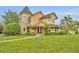 A charming two-story home featuring a turret and beautifully manicured landscaping at 1415 Brumley Rd, Chuluota, FL 32766