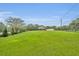 Expansive front yard with lush green grass and a beautiful home in the background at 1415 Brumley Rd, Chuluota, FL 32766
