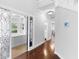 Hallway leading to a room with tub, showcasing hardwood floors and elegant architectural details at 1415 Brumley Rd, Chuluota, FL 32766