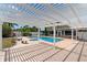Backyard featuring a pool and patio under a modern pergola, great for entertaining at 1415 Brumley Rd, Chuluota, FL 32766