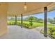Covered porch with decorative lighting and serene views of the well-maintained green lawn at 1415 Brumley Rd, Chuluota, FL 32766