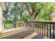 View of the back deck overlooking a grassy yard and mature trees at 1422 Russell Ave, Orlando, FL 32806
