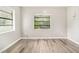 Bright bedroom with natural light streaming through the window, featuring modern hardwood flooring at 1422 Russell Ave, Orlando, FL 32806