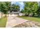 Classic home exterior with a spacious driveway and mature trees providing ample shade at 1422 Russell Ave, Orlando, FL 32806