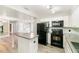 Well-lit kitchen featuring stainless steel appliances, white cabinets, and a functional layout for cooking at 1422 Russell Ave, Orlando, FL 32806