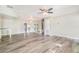 Open living room with sleek hardwood floors and ample natural light, complemented by stylish mirrored wall features at 1422 Russell Ave, Orlando, FL 32806