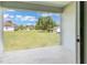 Covered back porch area offers a view of the expansive backyard and adjacent properties at 14322 Sw 28Th Ave, Ocala, FL 34473